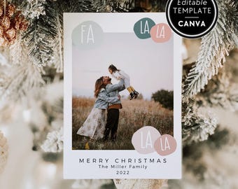 May include: A rectangular Christmas photo card template featuring a central photograph of two people in a field. The card includes the text FA LA LA, MERRY CHRISTMAS, The Miller Family, and 2022, with an Editable Template Canva badge.