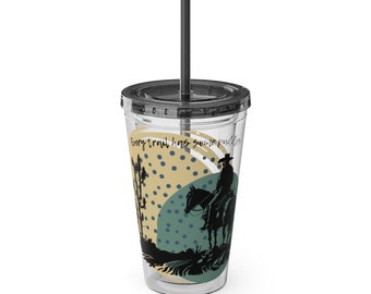 May include: Clear plastic tumbler with a black lid and straw. The tumbler features a graphic of a cowboy on a horse, with the text "Every trail has some puddles". The design includes tan, teal, and black elements.