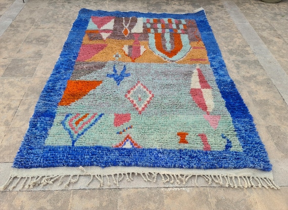 Handmade Moroccan Wool Rug: Tribal Boho Floor Decor with Bright Blue Border