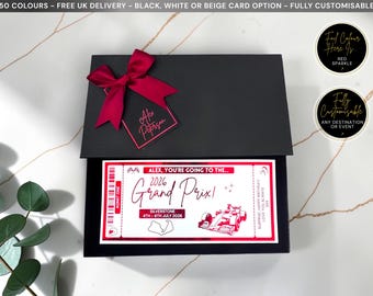 May include: A black rectangular gift box with a dark red ribbon bow and a matching tag labeled Alex Peterson. Inside, a white ticket with red accents reads: Alex, you're going to the 2026 Grand Prix, Silverstone, 4th-6th July 2026, featuring a race car graphic.