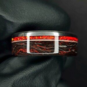 Titanium band, red marbled carbon fiber, crimson opal and white glow with red edge glow wedding band