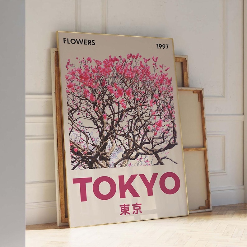 May include: A framed art print featuring a pink flowering tree against a light background. The word "FLOWERS" is at the top, with "1997" next to it. The word "TOKYO" is in large pink letters, with Japanese characters below.