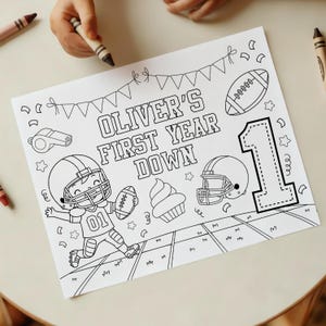 May include: Black and white coloring page with the text "OLIVER'S FIRST YEAR DOWN". The page features football-themed illustrations, including a football, helmet, and a cartoon football player. A large number "1" is also present.
