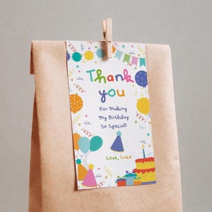 May include: A brown paper gift bag with a colourful birthday-themed tag. The tag reads "Thank you" with balloons, a birthday cake, and the text "For Making My Birthday So Special!" and "Love, Luca."