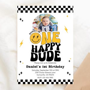 May include: A white invitation with a photo of a baby boy. The invitation has the text "ONE HAPPY DUDE" in yellow and black, with the name "Daniel" and the date of the birthday party. The invitation is decorated with lightning bolts and stars.