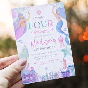 以下が含まれることがあります： 「It's Time Four a shellabration!」と「Madison's 4th Birthday」のテキストが入った、人魚をテーマにした誕生日招待状。人魚、海の生き物、バースデーケーキのイラストが、紫、青、ピンクの色合いで描かれています。