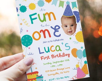 May include: A colorful birthday invitation with the text "It's Fun to be One" and "Luca's First Birthday." The invitation features a baby's face, balloons, a cake, and party hats. The date and time are also included.