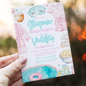 May include: A sleepover pool party invitation with watercolor illustrations. The invitation features a pink and teal color scheme, with images of a coconut, sleep mask, pajamas, robe, towels, popcorn, and a pool with a float.