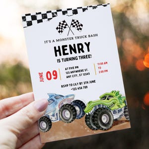 May include: A white invitation card with the text "IT'S A MONSTER TRUCK BASH" and "HENRY IS TURNING THREE!". Features a shark and a green monster truck illustration. Includes event details and RSVP information.