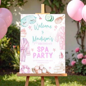 May include: A wooden easel displays a spa party sign with watercolor illustrations. The sign reads "Welcome to Madison's 7th Birthday SPA PARTY." Pink and teal accents decorate the sign, with images of spa items like robes, eye masks, and candles.