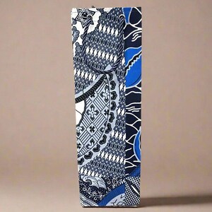 May include: A tall, rectangular box with a blue and white patterned design. The pattern features geometric shapes, swirls, and stars.
