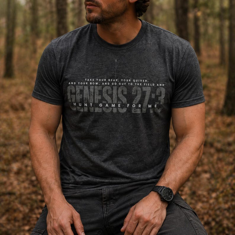 May include: Dark gray t-shirt with the text "TAKE YOUR GEAR, YOUR QUIVER, AND YOUR BOW, AND GO OUT TO THE FIELD AND GENESIS 27:3 HUNT GAME FOR ME" in a distressed font. The shirt is short-sleeved and has a crew neck.