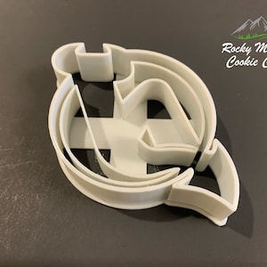 May include: White plastic cookie cutter shaped like the letter "A" with a double layer design.  The cookie cutter is on a dark grey surface.  Rocky Mountain Cookie Cutters is printed in the top right corner of the image.