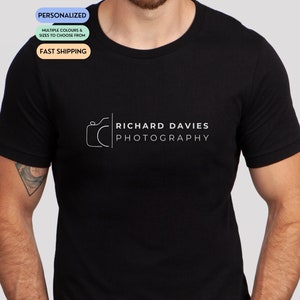 May include: Black t-shirt with a white camera icon and the text "Richard Davies Photography" printed on the front.