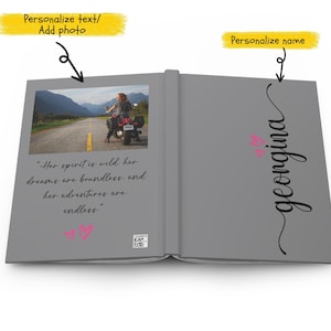 May include: A gray book with a photo of a woman riding a motorcycle on a road with mountains in the background. The text "Her spirit is wild. her dreams are boundless. and her adventures are endless." is printed on the left page. The name "georgina" is written in cursive on the right page.