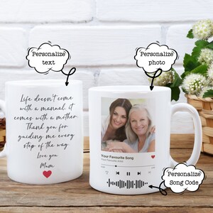 May include: White ceramic mug with a photo of two women and a music player with a song code. The mug has text that reads "Life doesn't come with a manual. It comes with a mother. Thank you for guiding me every step of the way. Love you Mam".