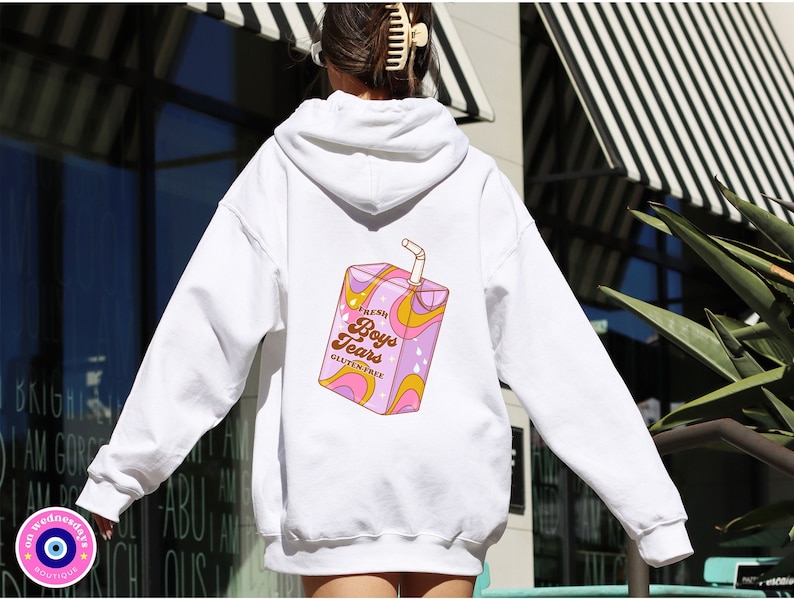 May include: White hoodie with a graphic of a pink and yellow juice box with the text "Fresh Boys Tears Gluten Free" printed on the back.