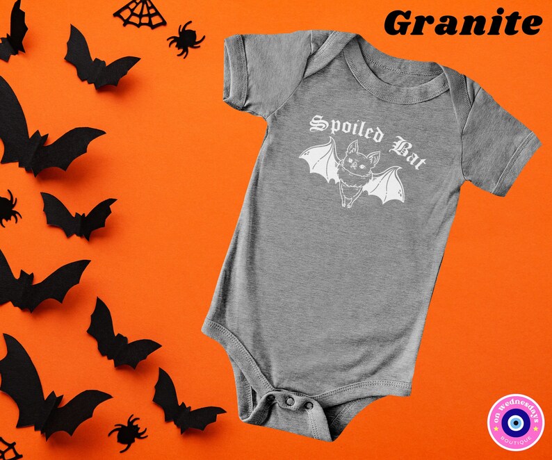 May include: A gray baby onesie with a white graphic of a bat with the text "Spoiled Bat" in a gothic font.