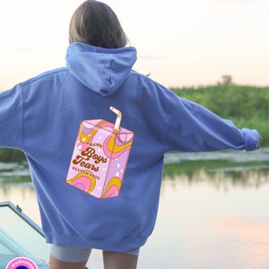 May include: A blue hoodie with a graphic of a pink and yellow juice box with the text "Fresh Boys Tears Gluten-Free" on the back.