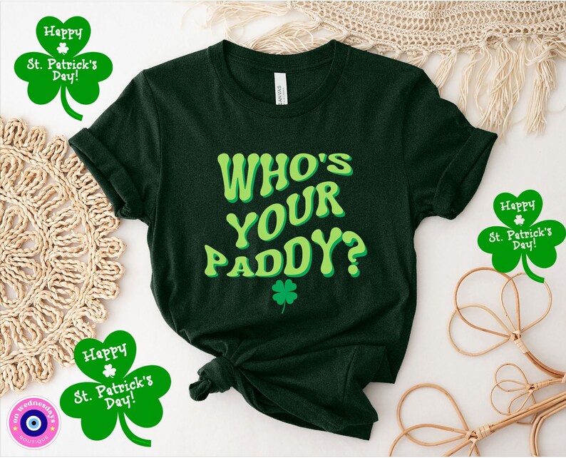 May include: A dark green t-shirt with the text "WHO'S YOUR PADDY?" in a green and yellow font. The shirt is decorated with a green shamrock.