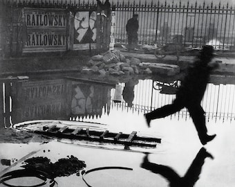 Henri Cartier-Bresson Print – Man Leaping Over Puddle, The Decisive Moment