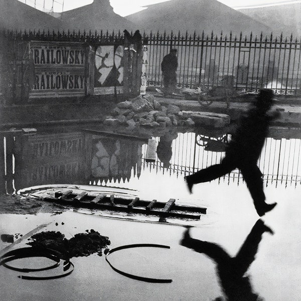 Man Leaping Over a Puddle - Henri Cartier-Bresson   - Canvas, Metal, Acrylic, or Giclee Quality Prints  - Mounting Hardware Included!