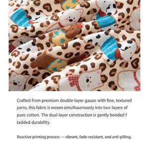 May include: Close-up of a beige fabric with a repeating pattern of cartoon bears and leopard spots. The bears wear blue and brown outfits. The fabric is made of double-layer gauze.