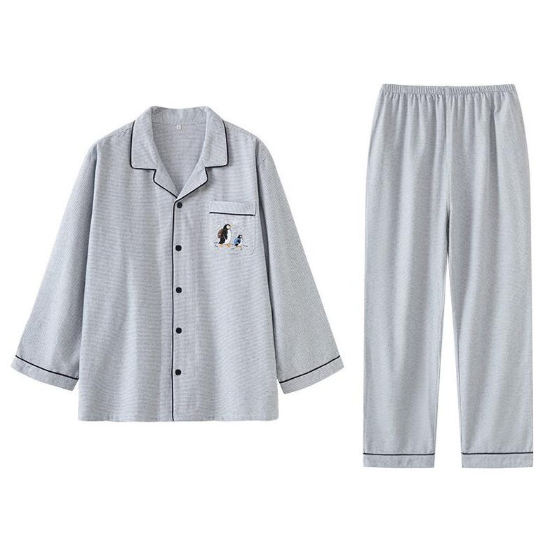May include: Light gray pajama set with a button-down shirt and matching pants. The shirt features a small embroidered design of two birds. The set has black trim and is made of a soft, comfortable material.