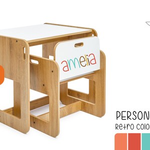 May include: A wooden children's table and chair set with a white top. The chair has a cutout for a child to hold onto. The table has a white surface with the name "amelia" written in colorful letters. The set is made in Texas.
