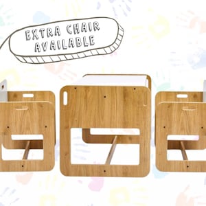 May include: A wooden children's table and two chairs set. The table has a white top and the chairs have a storage compartment. The set is made of natural wood and has a simple, modern design.  "Extra chair available" is written on a speech bubble above the set.