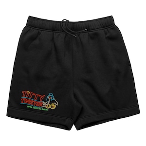 May include: Black shorts with a drawstring waist. The shorts feature a neon-style graphic with the words "Titty Twister" and the phrase "Open Dusk Till Dawn". The graphic includes an image of a woman and a circular design.