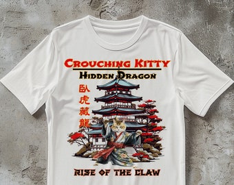 May include: White t-shirt with a graphic of a cat in a kimono holding a sword in front of a Japanese pagoda. The text "Crouching Kitty Hidden Dragon Rise of the Claw" is printed on the shirt. The text "卧虎藏龍" is also printed on the shirt.