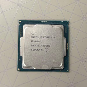 May include: A square Intel Core i7-8700 processor with a silver metal heat spreader and a dark green circuit board base. The text printed on the surface reads Intel Core i7, i7-8700, SR3QS 3.20GHz, and X009G441 with a small circular e4 logo.