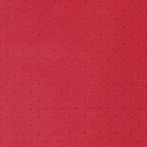 May include: A close-up of a red fabric with a repeating pattern of small, evenly spaced, dark brown dots. The fabric has a slightly textured appearance, and the dots are uniformly sized and colored.