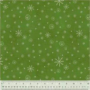 May include: Green fabric with a pattern of white snowflakes and spiral designs. The fabric has a textured appearance, with a ruler along the bottom edge. The design is suitable for holiday-themed crafts and projects.