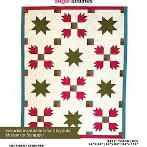 May include: A quilt pattern titled "Campfire S'mores" by Ledine Watson. The quilt features a white background with a repeating pattern of olive green star shapes and red and white floral designs. The pattern includes instructions for two layouts and is sized 44" x 44".