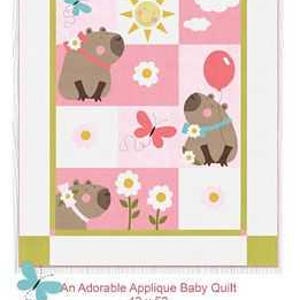 May include: An applique baby quilt featuring capybaras, flowers, butterflies, and a sun on a pink and white patchwork design. The quilt measures 42 x 52 inches.