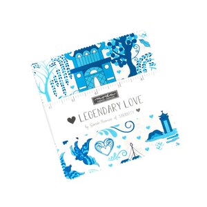 May include: A white fabric square with a blue and white pattern featuring architectural designs, trees, and hearts. The text "LEGENDARY LOVE" is printed on the fabric, along with the brand name "moda".