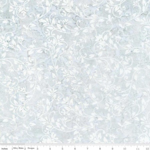 May include: A fabric with a light blue and white floral pattern. The design features white vines and leaves on a textured background. The fabric is measured in inches, with a ruler along the bottom.