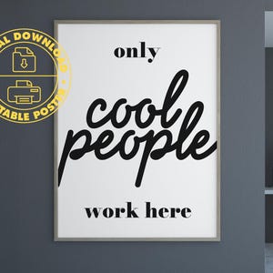 May include: A framed poster with the text "only cool people work here" in black on a white background. The poster is in a room with a desk, chair, and lamp. A digital download printable poster logo is in the upper left corner.