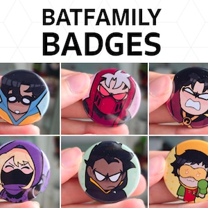 May include: A collection of circular badges showcasing Batfamily characters. Each badge has a different character design with distinct colours and expressions. The text "BATFAMILY BADGES" is displayed above. These badges are likely collectible accessories.