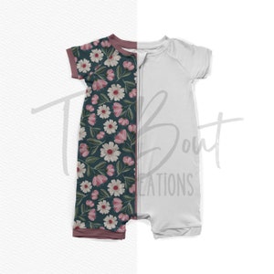 May include: A white and teal baby sleeper with a floral print featuring pink flowers and green leaves. The sleeper has a zipper down the front and a maroon trim around the neck and sleeves.