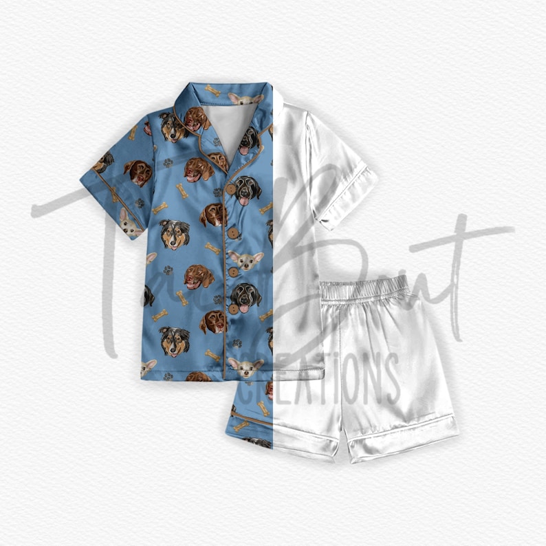 May include: A blue and white pajama set with a dog print on the top. The top has a button-up front and short sleeves. The shorts are white and have a satin finish.