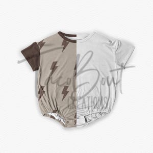 May include: A brown and white baby onesie with a lightning bolt pattern on one side. The onesie has short sleeves and a snap closure.