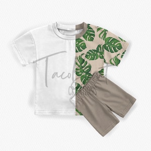 May include: A two-piece toddler outfit with a white short-sleeved t-shirt and beige shorts. The t-shirt has a tropical leaf print on one side.
