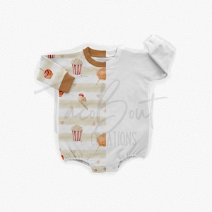 May include: A white long-sleeved baby onesie with a brown and white striped pattern on the left side and a plain white side on the right. The striped side features a watercolor design of popcorn, ice cream cones, cotton candy, and candy apples.