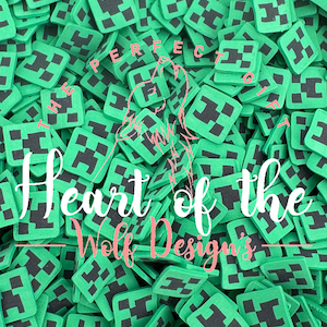 May include: A large quantity of green and black Minecraft-themed square-shaped charms. The charms feature a pixelated green block with a black outline and a black pixelated 'H' inside. The text 'Heart of the Wolf Designs' is visible in the center of the image.