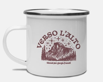 May include: White enamel mug with a brown graphic of a mountain range with stars and the text "VERSO L'ALTO -blessed pier giorgio frassati".