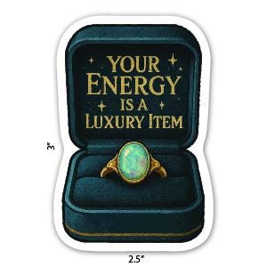 May include: A sticker featuring a teal ring box with gold text that reads "YOUR ENERGY IS A LUXURY ITEM." Inside the box is a gold ring with a large, oval, opalescent stone. The sticker is 3 inches tall and 2.5 inches wide.