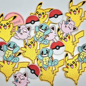 May include: A collection of embroidered patches featuring Pikachu, Squirtle, Jigglypuff, and Poké Balls. The patches are yellow, blue, pink, red, and white. Pikachu patches have a lightning bolt tail. Ideal for decorating clothing or accessories.